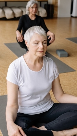 Elison Park | Senior woman doing yoga in a group