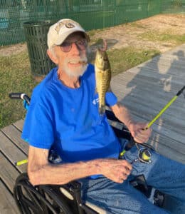 Elison Park | Senior man showing the fish he caught